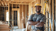 © CreativeTrends - Happy black man construction worker wearing a hardhat working in a home, house renovation and builder concept