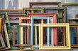 © Nature Lover - A stack of empty picture frames leaning against a wall.
