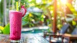 Dragon fruit smoothie in glass on table in tropical cafe outdoor