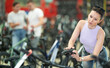 Adult woman buyer chooses bicycle in sports store