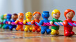Diverse team unity. Line of miniature plastic figures engaged in a tug of war match on a wooden surface, reflecting teamwork and competition. The importance of working together towards a common goal.