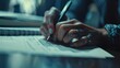 © Zidan - close up view of human hand writing something on paper with pen.Ai generated