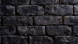 a close-up view of a dark, textured brick wall. The bricks appear to be uniformly colored and shaped, with no visible mortar between them