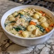 Chicken Gnocchi Soup served in a white ceramic bowl rich and creamy, featuring tender chunks of chicken, soft potato gnocchi