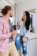 © Wavebreak Media - Diverse couple enjoying coffee in kitchen at home