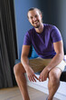 © Wavebreak Media - Caucasian young man sitting, smiling at camera at home