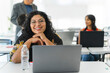© STOCKEROcr - Portrait of a smiling Latina woman looking at the camera at the university.
