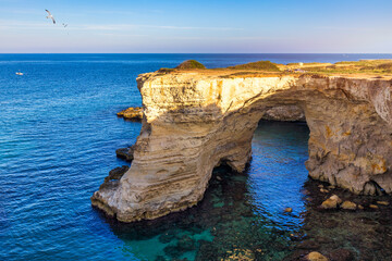 Wall Mural - Stunning seascape with cliffs rocky arch and stacks (Faraglioni) at Torre Sant Andrea, Salento coast, Puglia region, Italy. Beautiful cliffs and sea stacks of Sant'Andrea, Salento, Apulia, Italy