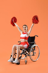 Poster - Young cheerleader in wheelchair on orange background