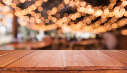 Wall Mural - Image of wooden table in front of abstract blurred background of restaurant lights on black for montage products