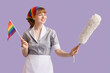 Young chambermaid with LGBT flag and pp-duster on lilac background