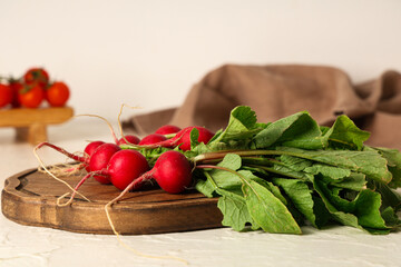 Wall Mural - Wooden board with fresh radish on light background