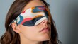 A designer sleep mask featuring a bold abstract print fusing fashion and function for a truly deluxe experience.