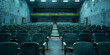A image of empty seats in a theater or cinema, with rows of chairs awaiting the arrival of an audience for the next performance