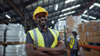 © Stock Creator - Smiling African American warehouse worker in safety gear at distribution center