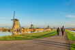 Dutch Windmill landscape at Kinderdijk Village Netherlands with love couple walking