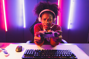 Wall Mural - Host channel of gaming streamer, African girl playing online game with joystick, talking with viewers media online on microphone. Esport skilled team players in neon color lighting room. Tastemaker.