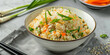 bowl of fried rice with vegetables, green spring onion and carrot on top, generative AI