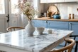 © Nia™ - Empty and clean marble dining table in scandinavian kitchen. Modern monochrome interior with blue drawers on wooden furniture. Tablewear and vases with flowers - generative ai