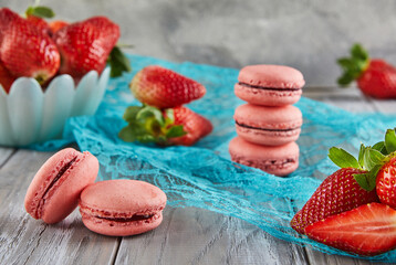 Sticker - Fresh strawberries and macarons atop a blue tablecloth