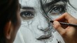 An artist's pencil hovers over a detailed pencil drawing of a woman's face.
