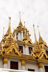 ornate and gold stupas on buddhist temple in bangkok thailand