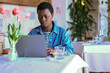 Focused young african american woman  use laptop at cafe