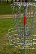 Disc golf basket in park setting