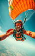 A happy man in an orange jumpsuit skydives through the air. Vert