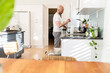 Man doing dishes in a sunny and bright kitchen