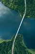 Aerial view of bridge asphalt road with cars and blue water lake and green woods