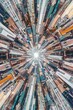 A cityscape viewed through a kaleidoscope lens, creating a mesmerizing fractal pattern of buildings and streets that multiply infinitely into surreal urban symmetry