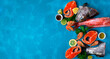 Fresh seafood assortment on blue background with copy space. Trout steaks, beaked redfish and shrimps.  Cooking ingredients. Top view