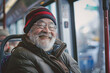 © Di Studio - portrait of cheerful senior man sitting in public transport, bus or train