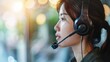 © millenius - Happy smiling operator asian woman customer service agent with headsets working on computer in a call center.