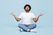 © ViDi Studio - Full body young happy Indian man wear white t-shirt casual clothes sits hold spreading hands in yoga om aum gesture relax meditate try to calm down isolated on plain pastel light blue cyan background.
