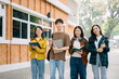 © Nuttapong punna - Young people college students is reading a book while relaxing sitting on grass in a campus park