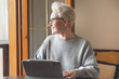 © Karyna - Middle-Aged Mature Business Woman Working At Tablet, Participate In Corporate Training, Video Conferencing. Concept Of Working Woman. Self-development after age 40. Personal growth or change after 45.