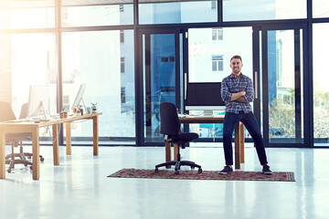 Fototapete - Man, manager and office for success on desk, creative and workplace leader. Entrepreneur, boss and web design agency with male ceo, business and technology for startup company and sitting on table