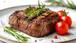 Juicy beef steak medium rare with rosemary, tomatoes and pepper