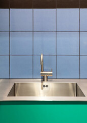 Wall Mural - Kitchen interior with metal sink and chrome faucet against blue wall tile