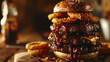 Double decker burgers stacked high, crowned with golden onion rings and smoky barbecue sauce.