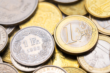 Euro and Swiss Franc coins next to each other, 1 euro and 1 CHF coins