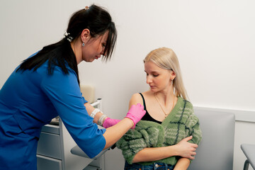 in a private clinic in the analysis room a doctor makes a vaccine in the patient s shoulder