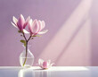 Beautiful pink magnolia flower in transparent glass vase standing on white table with sunlight on pastel pink wall