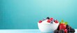 A delicious bowl of yogurt and berries on a vibrant background perfect for copy space image