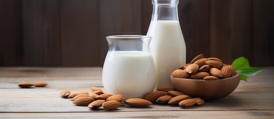 Aufkleber - A copy space image of almond milk and almonds displayed on a wooden background