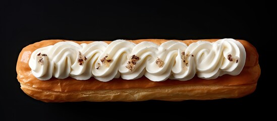 Fototapete - A cream filled eclair is seen from above in a photo with ample space for additional elements emphasizing its sweetness and inviting quality