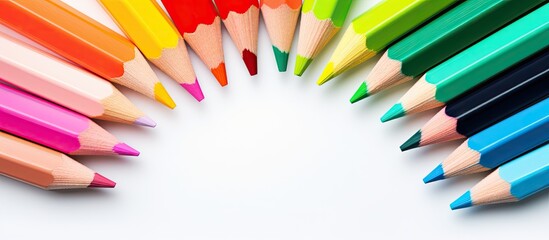 Poster - A copy space image showing colorful pencils placed in the center on a white background Ideal for kids to study and learn art as they go back to school