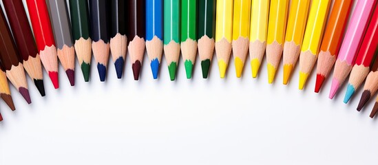 Poster - A copy space image showing colorful pencils placed in the center on a white background Ideal for kids to study and learn art as they go back to school